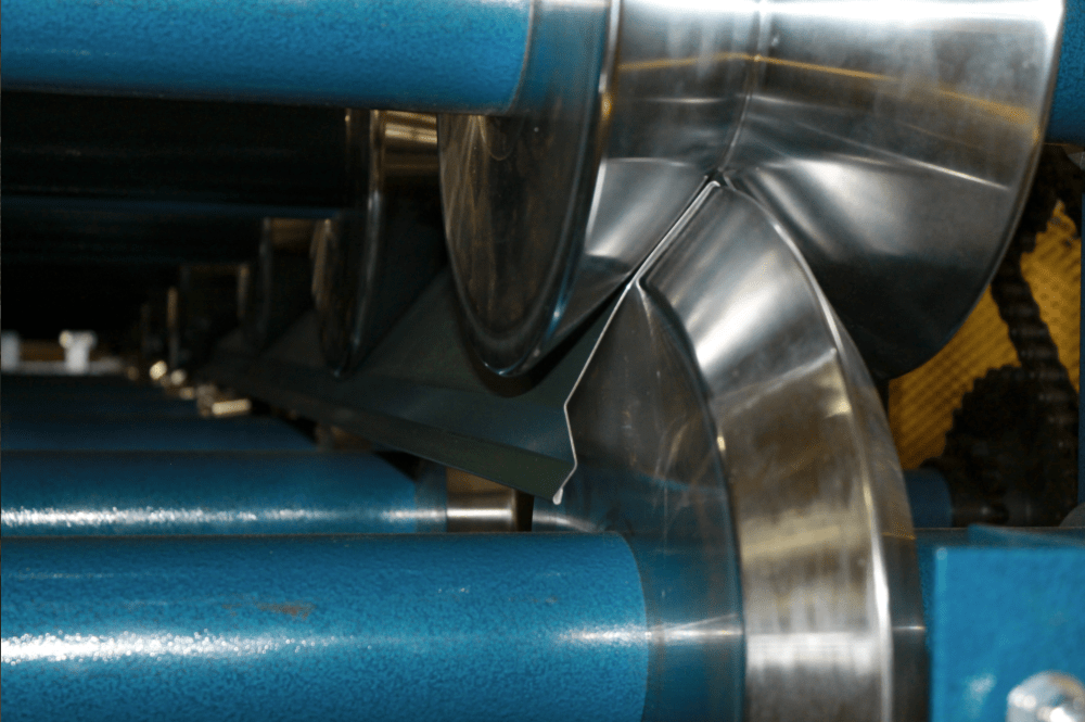 Wheels pressing sheet metal into desired shape